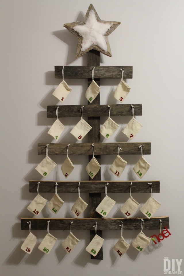 Rustic Advent Calendar. Giant Wall Mounted Advent Calendar perfect for a Rustic Christmas. This DIY advent calendar is over 4 Feet tall. Follow this step by step tutorial so that you can make one for your family! | thediydreamer.com