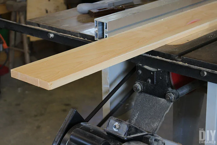 Cut wood boards with a table saw.