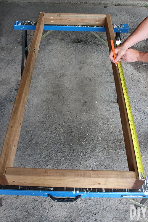 Measure the sides to find the center of the frame.