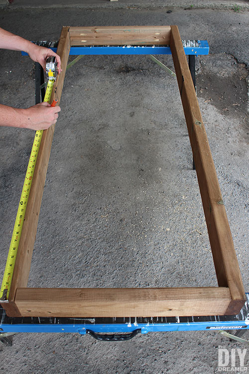 Measure the sides to find the center of the frame.