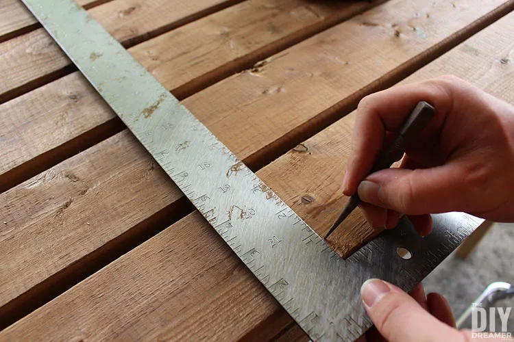 Make punch holes in the wood to mark where to insert screws. Using a square will make sure the line is straight.