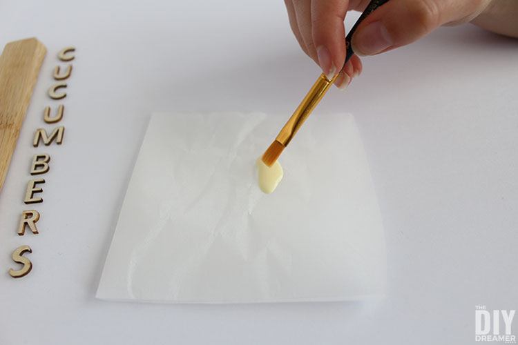 Dipping paint brush into the glue.
