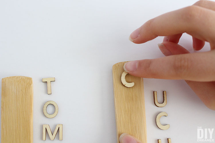 Pressing down on the letter.