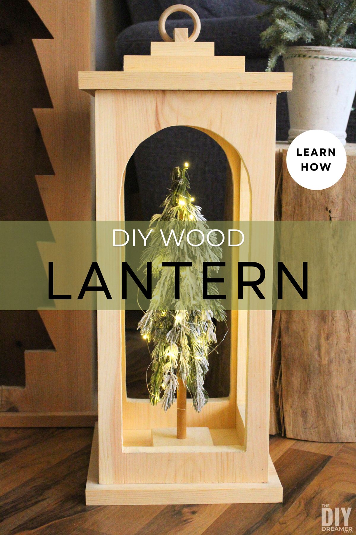 DIY Wood Lantern with a small Christmas tree with lights inside.